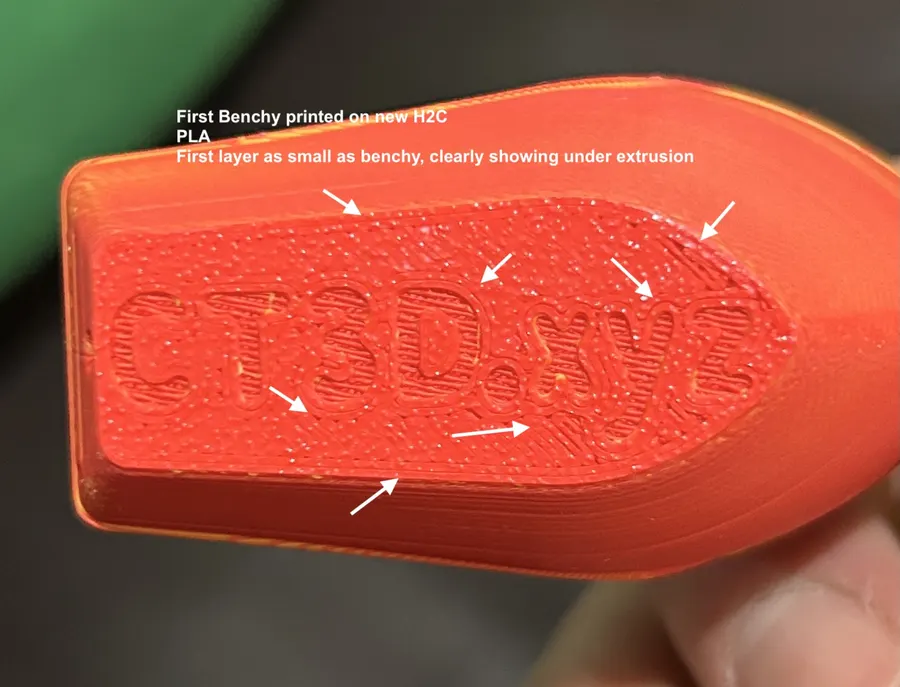 Close-up of the underside of the first PLA Benchy printed on the new H2C, arrows pointing at pinholes and visible layer lines