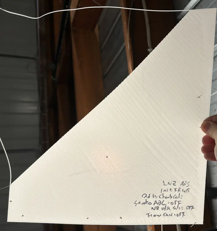 ABS first layer with massive over-extrusion, wavy bulging lines across the plate
